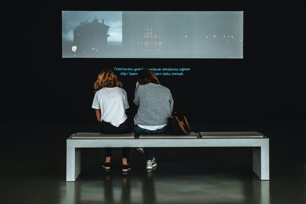 two women sitting on table